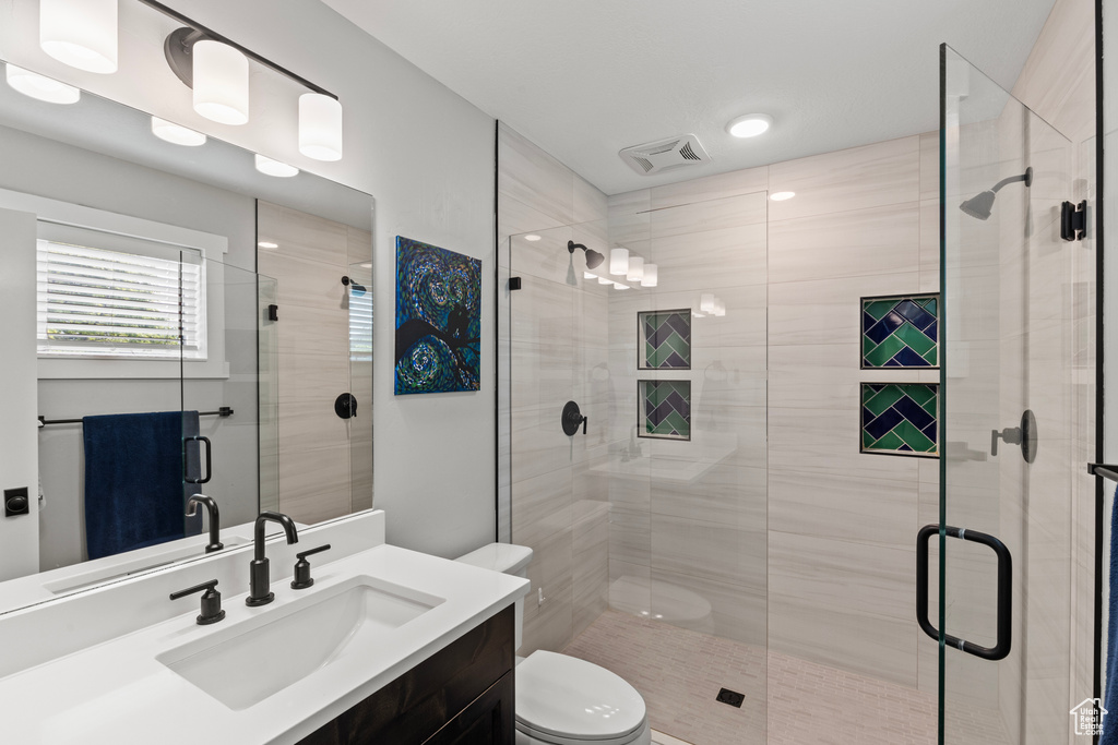 Bathroom with vanity and a shower stall