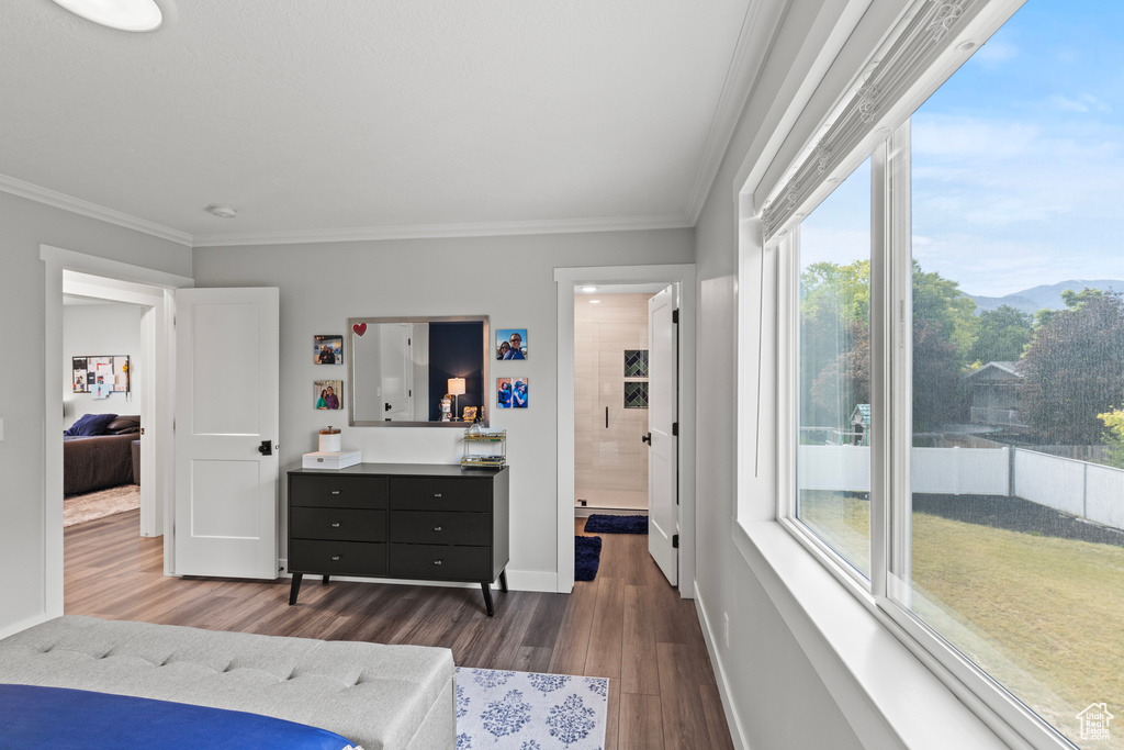 Bedroom featuring dark wood finished floors and ornamental molding