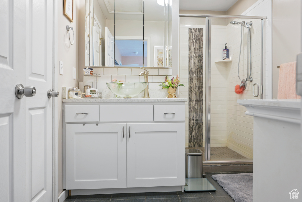 Bathroom with vanity, a stall shower, and tile patterned flooring