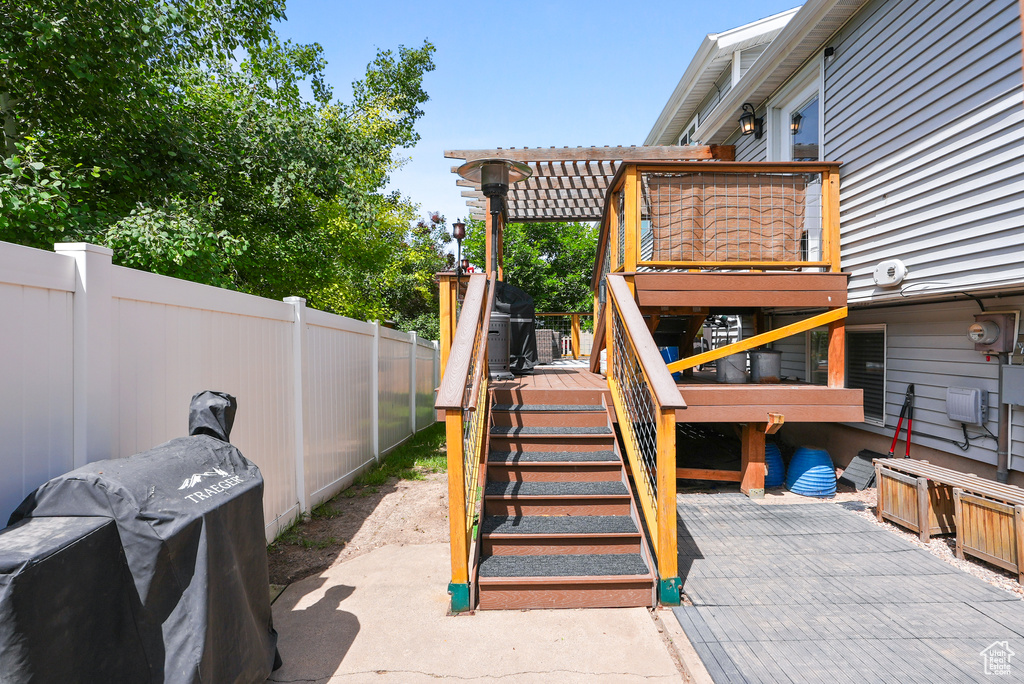 View of patio / terrace featuring a wooden deck and stairway