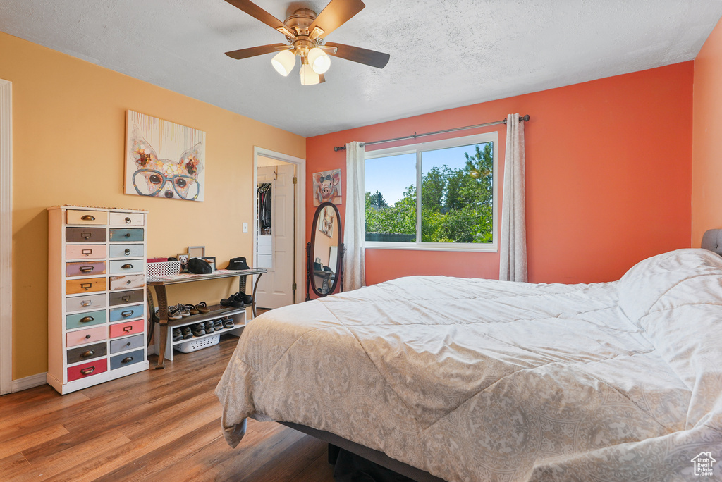 Bedroom featuring wood finished floors and ceiling fan