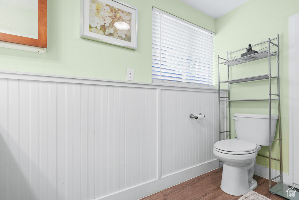 Bathroom with wood finished floors and a wainscoted wall
