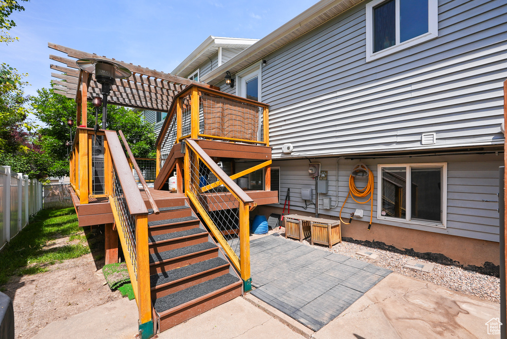 View of patio featuring stairs, a pergola, and a wooden deck