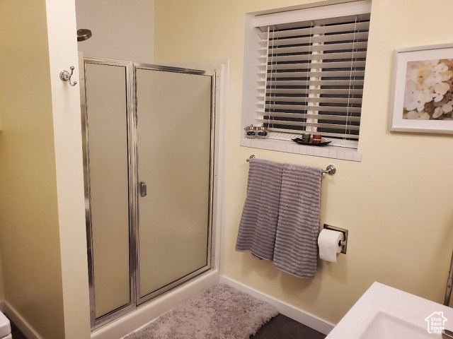 Full bath featuring a shower stall