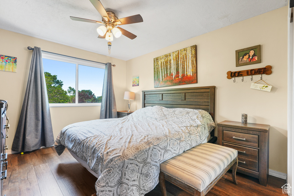 Bedroom with dark wood finished floors and ceiling fan