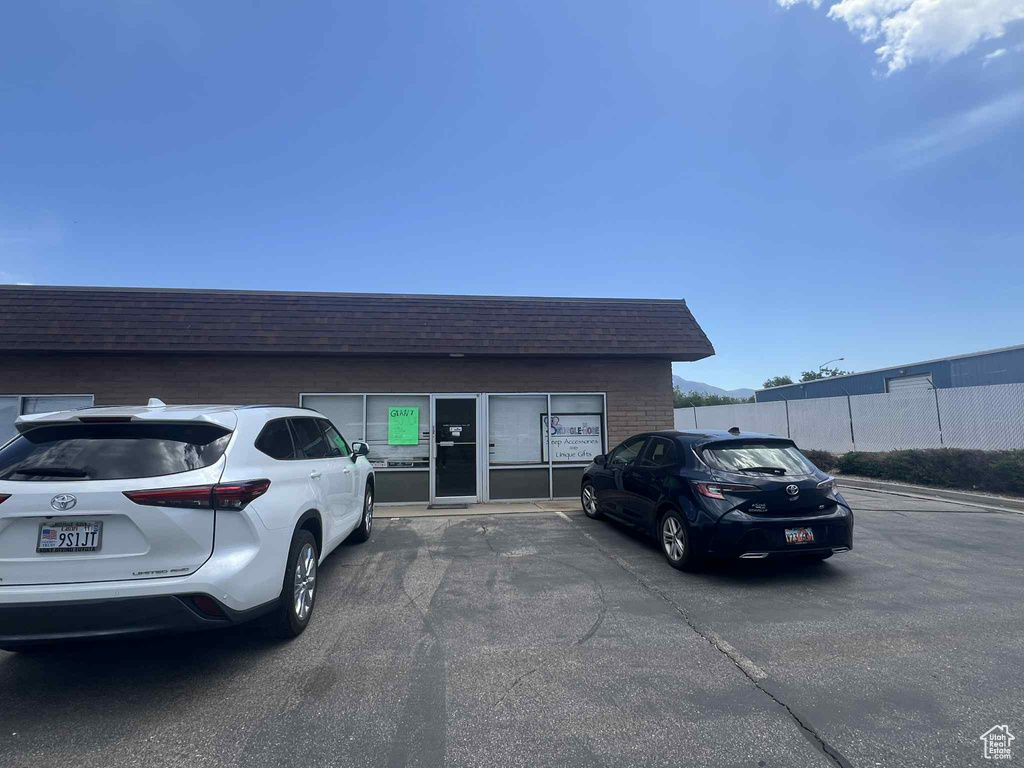 View of building exterior with uncovered parking