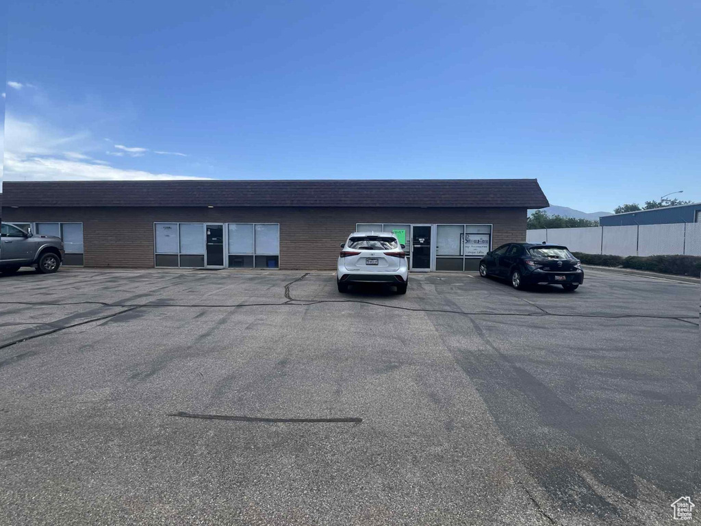 View of building exterior with uncovered parking