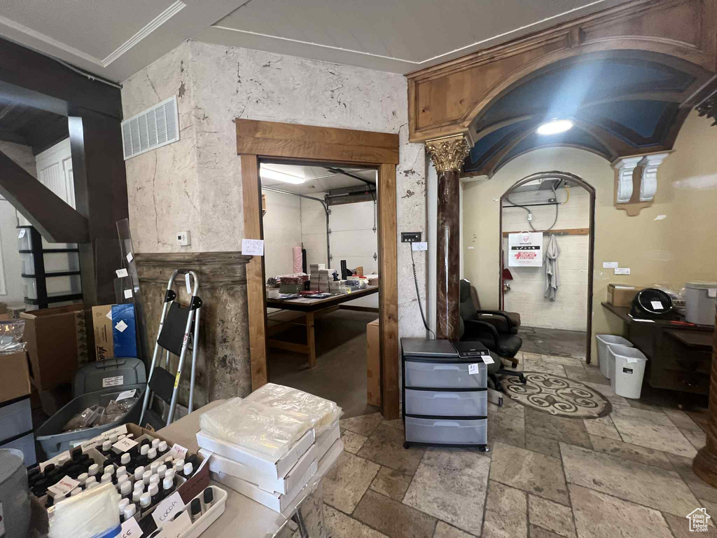 Interior space featuring stone tile floors and ornate columns