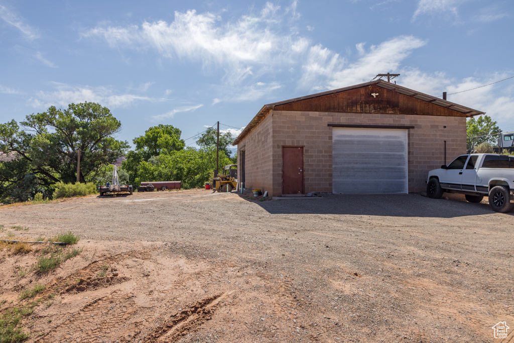 Detached garage with dirt driveway