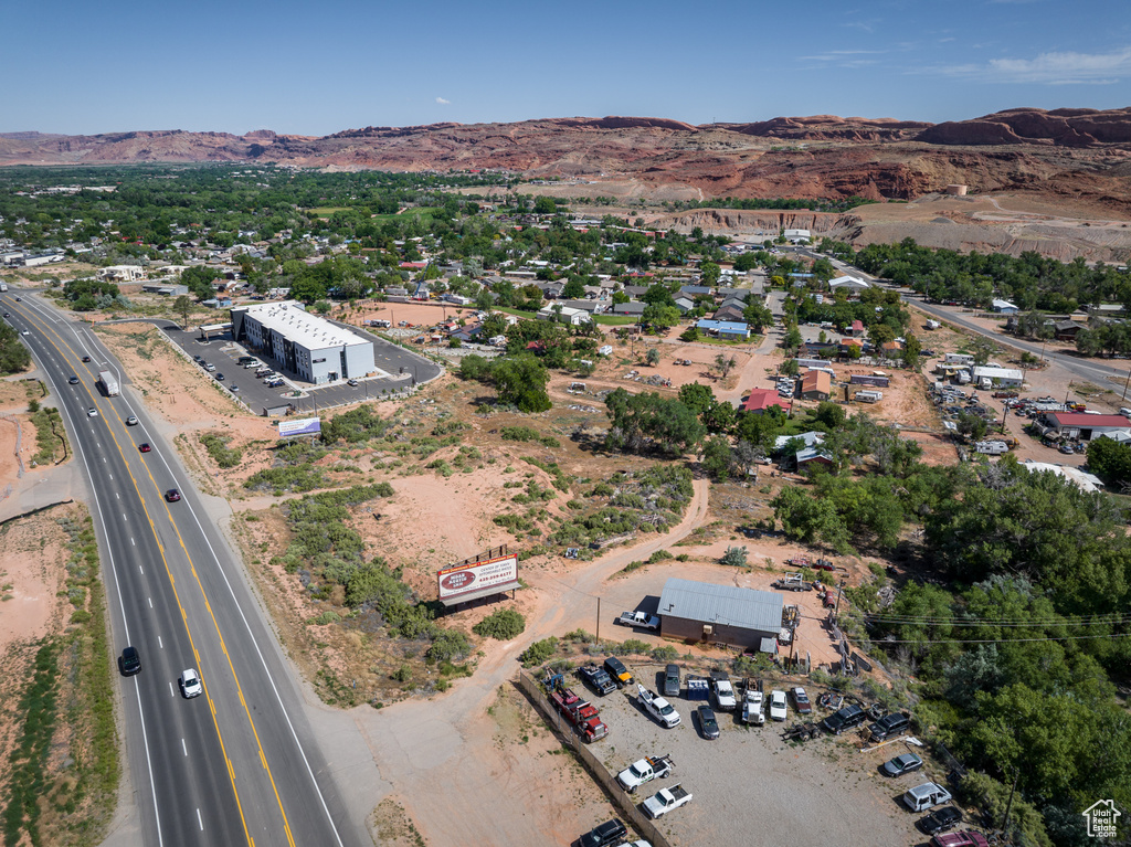Aerial view of a mountain backdrop and a major roadway