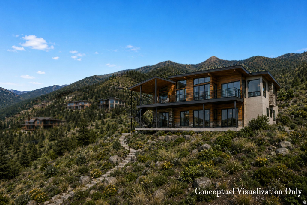Contemporary multi-level exterior with extensive glazing, stone accents, and wood-finish siding