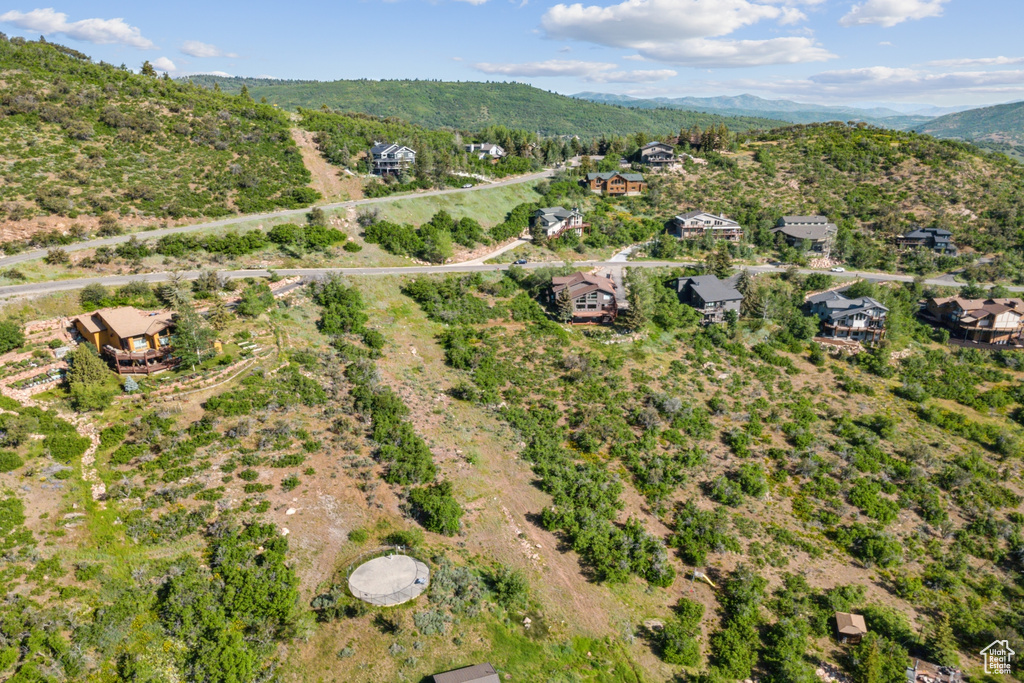 Aerial view of property's location with a mountain backdrop