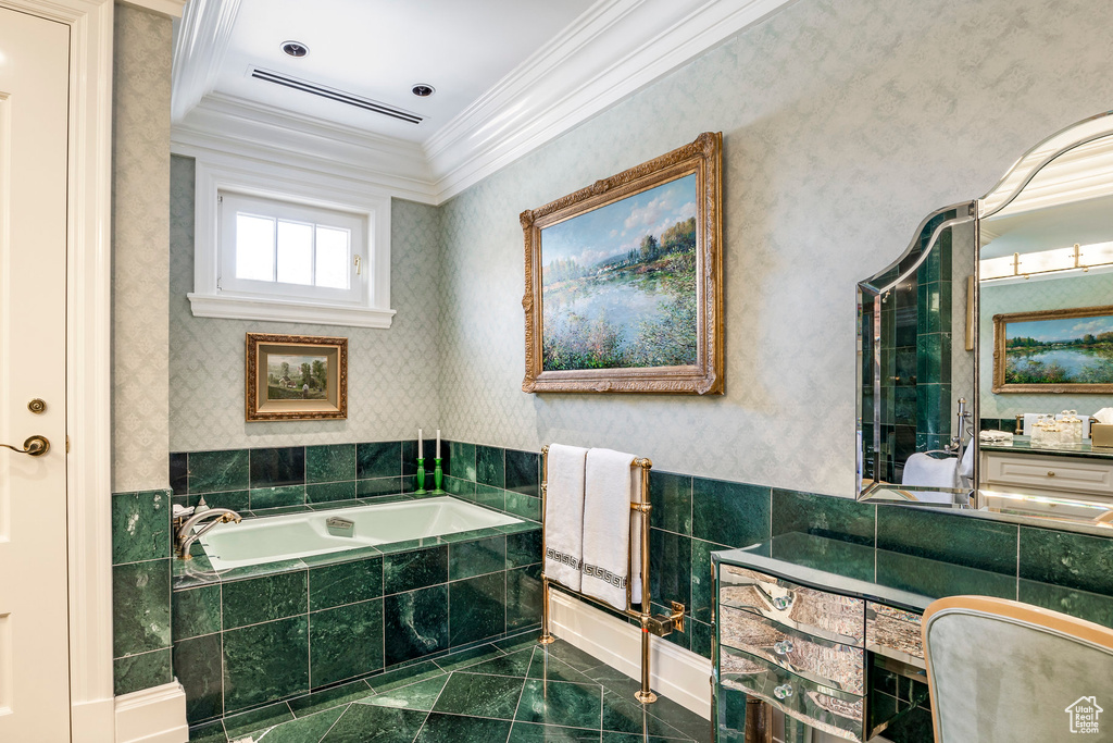 Bathroom featuring crown molding, a bath, marble look tiles, and vanity