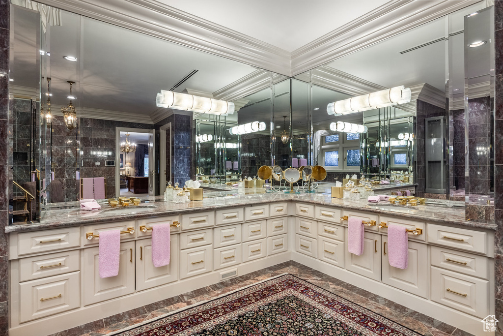 Full bathroom with crown molding, vanity, and a chandelier