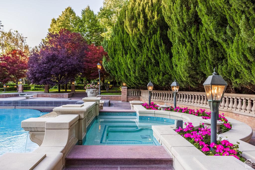 Swimming pool with an in-ground hot tub