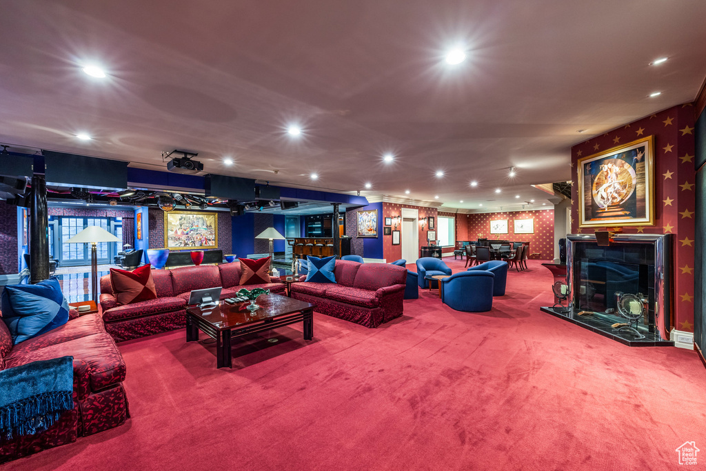 Living room with wallpapered walls, carpet floors, and recessed lighting