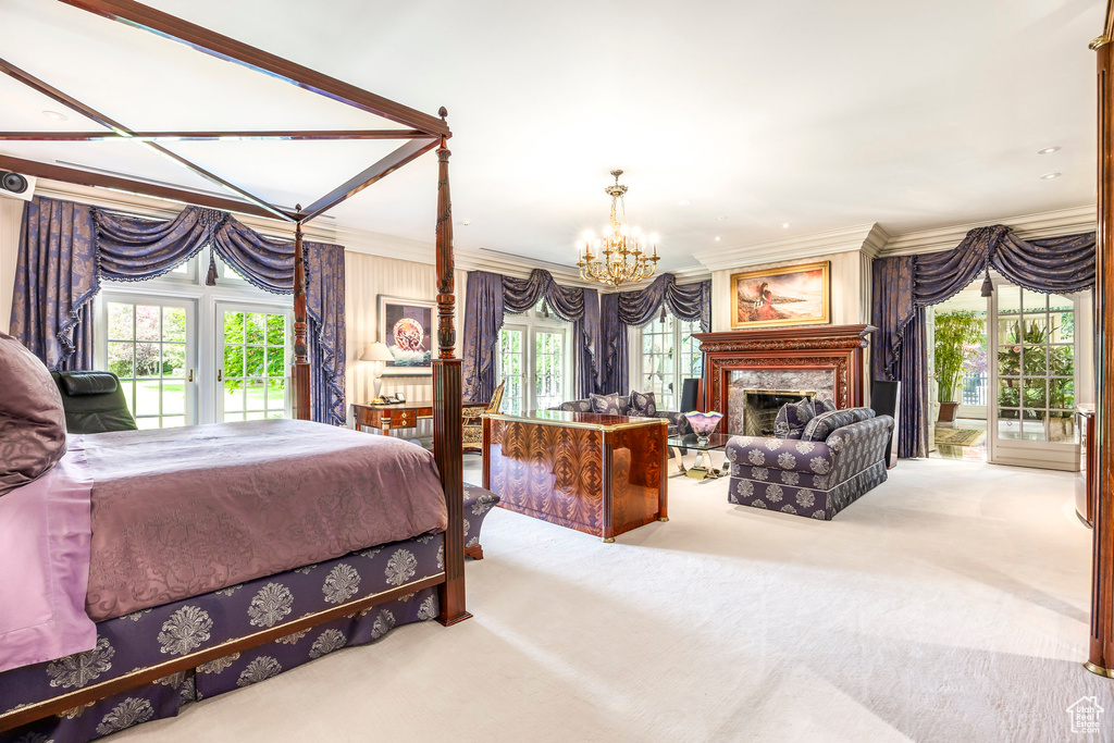 Bedroom featuring crown molding, carpet flooring, a chandelier, access to outside, and multiple windows