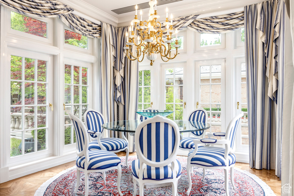 Sunroom / solarium with french doors and a chandelier