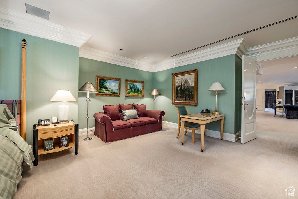 Carpeted living room with crown molding and baseboards