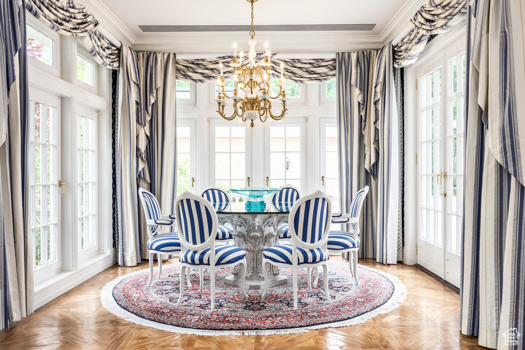 Dining area featuring french doors, a chandelier, and ornamental molding