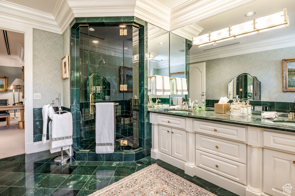 Bathroom featuring crown molding, vanity, a shower stall, and wallpapered walls