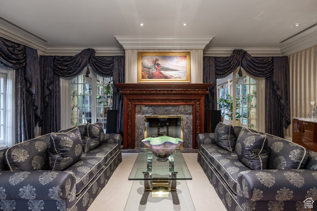 Living area featuring a high end fireplace and ornamental molding
