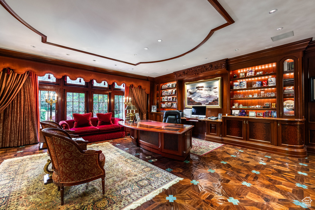 Office space with built in features, recessed lighting, and ornamental molding