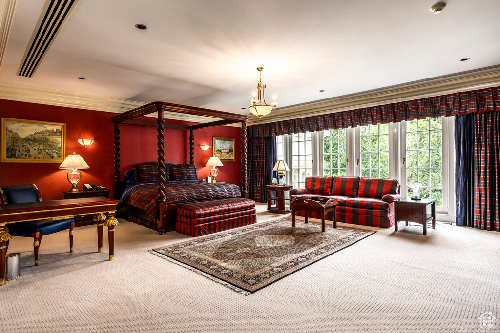 Carpeted bedroom featuring ornamental molding and a chandelier