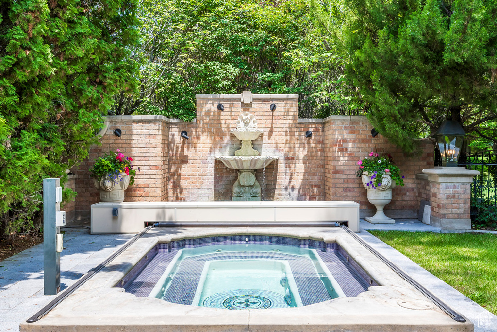 View of pool with an in-ground hot tub