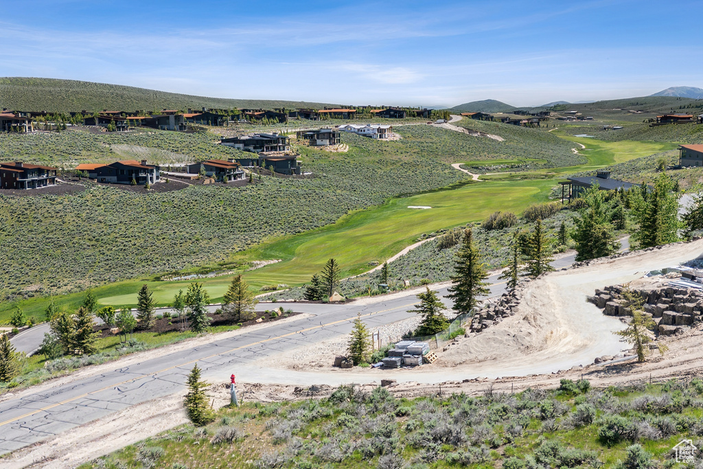 Drone / aerial view of a golf course and mountains