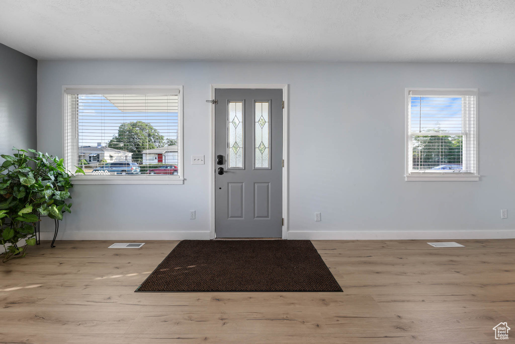 Foyer entrance with wood finished floors