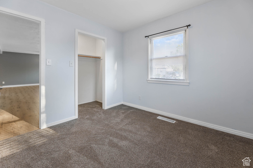 Unfurnished bedroom featuring carpet floors and a closet