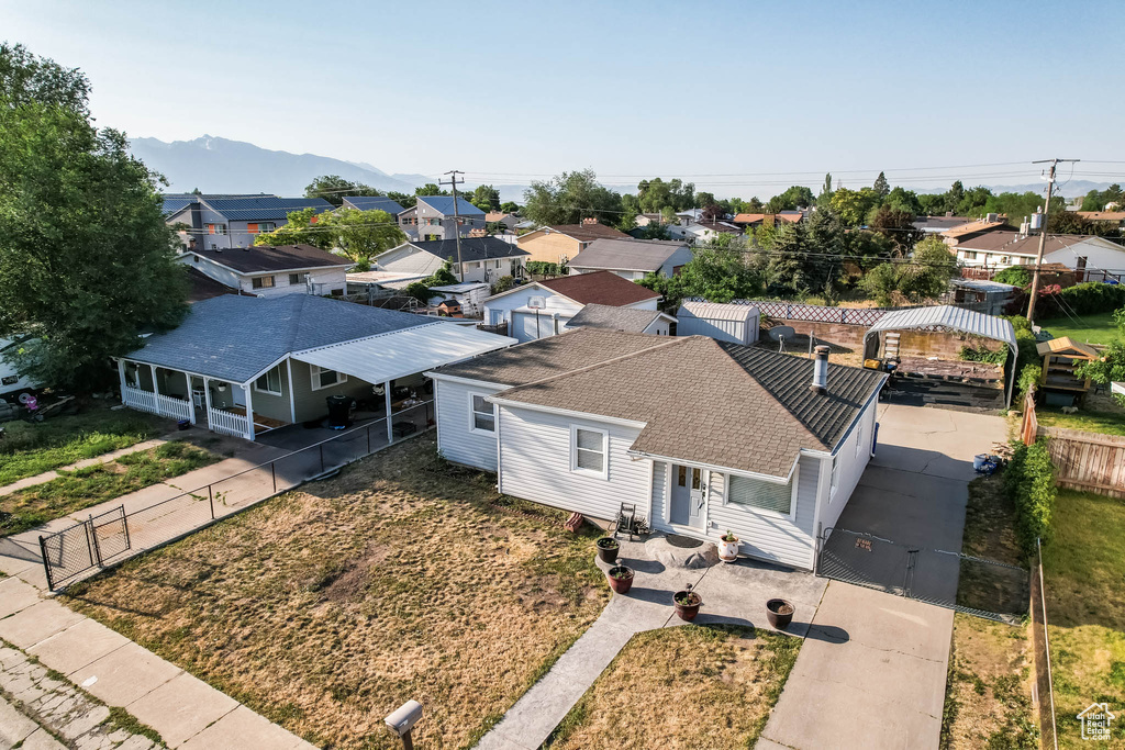 Aerial view of residential area featuring a mountainous background
