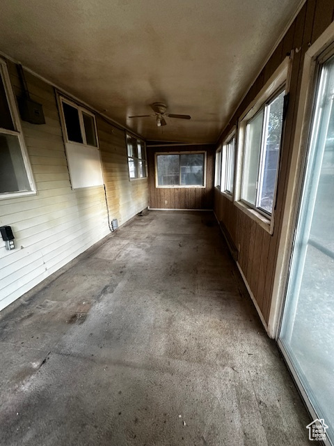 Unfurnished sunroom with ceiling fan
