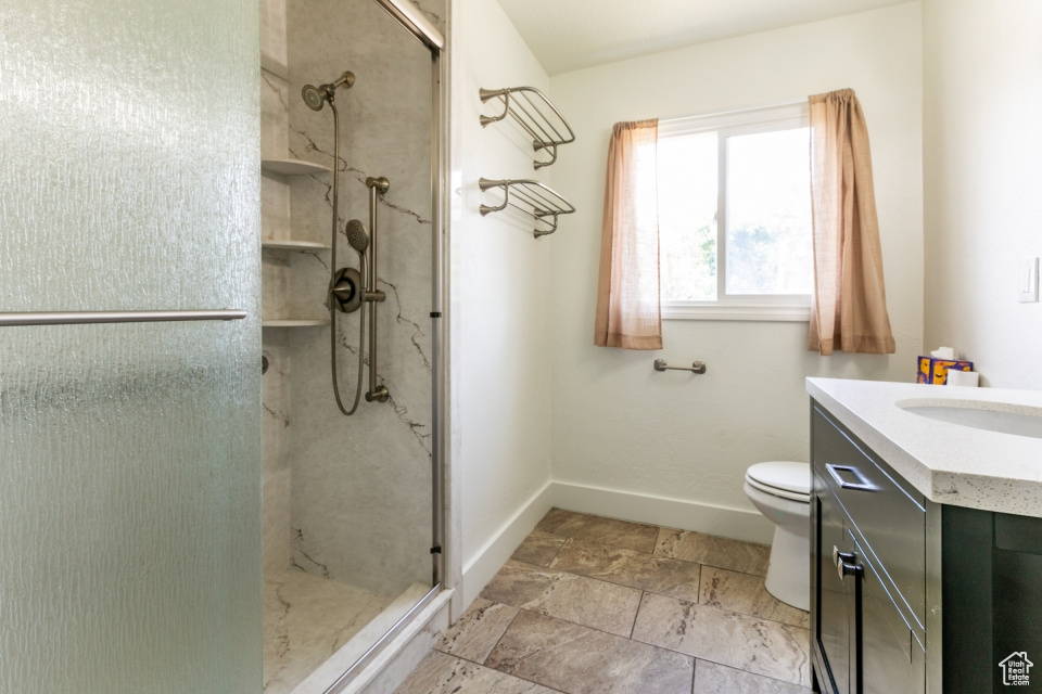 Bathroom featuring a stall shower and vanity