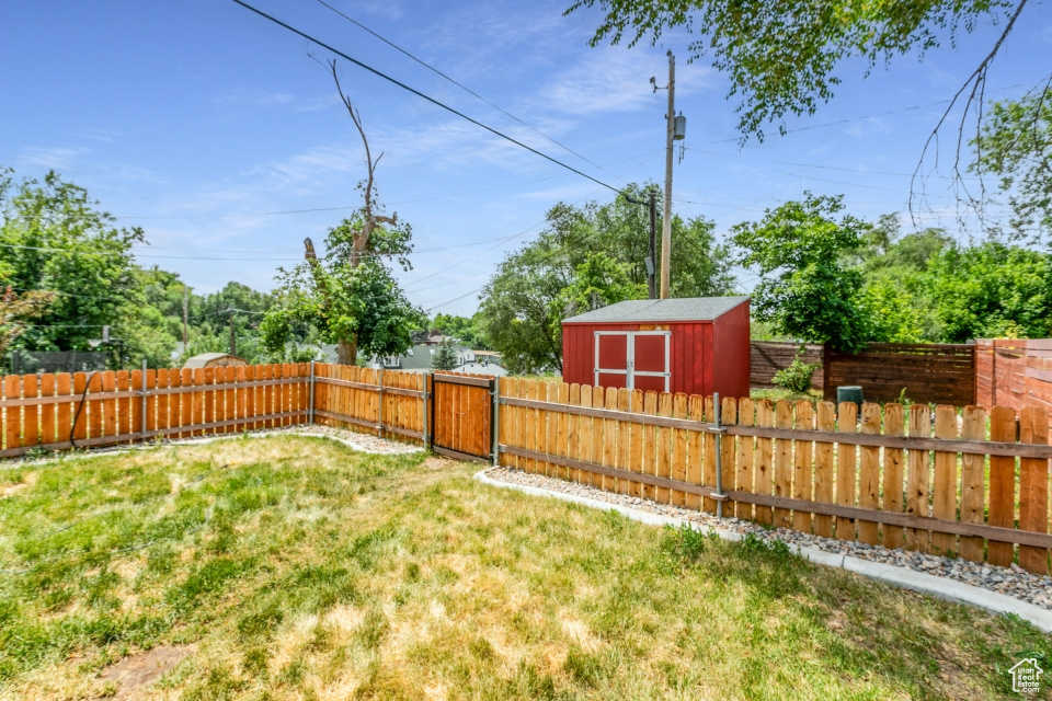 Fenced backyard with a storage unit