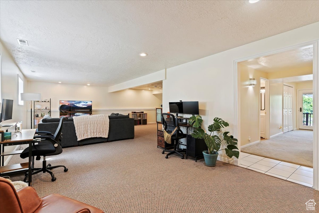 Tiled home office with carpet floors, a textured ceiling, and recessed lighting