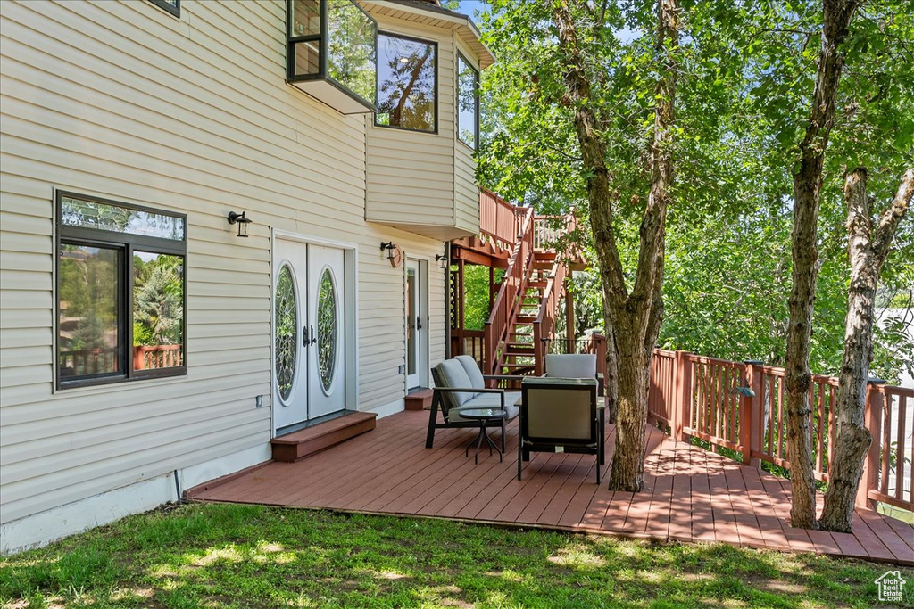 Wooden deck featuring stairs and french doors