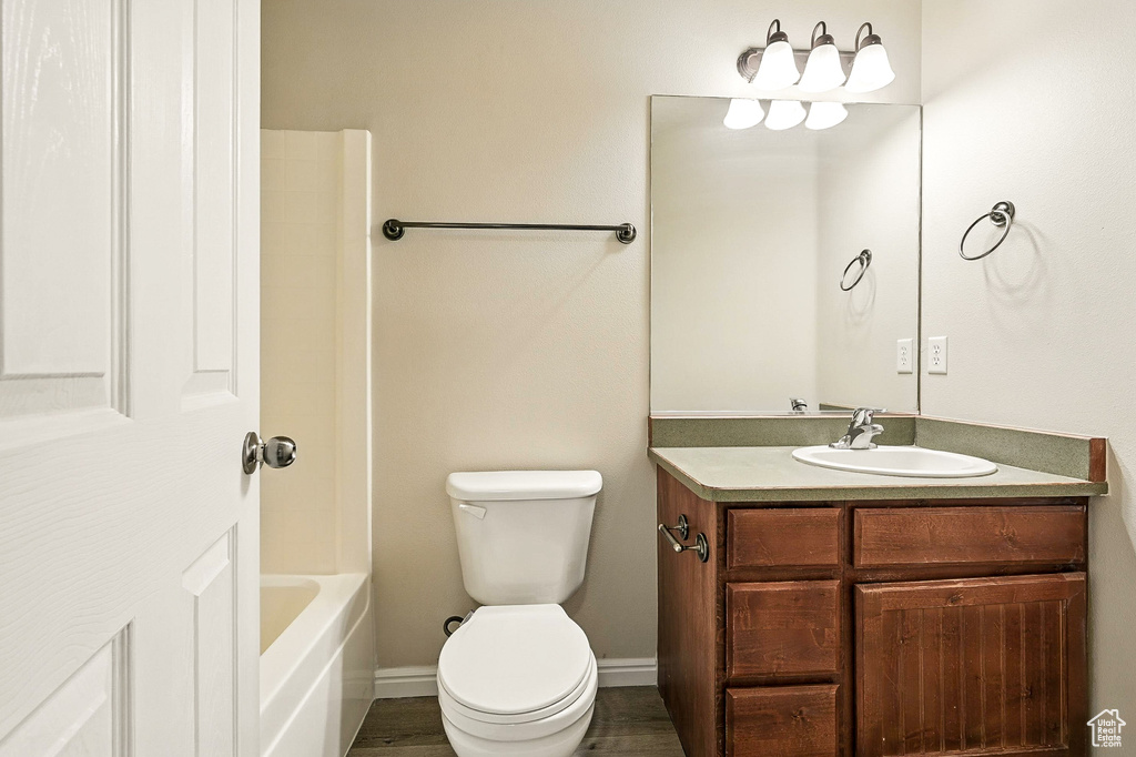 Full bathroom featuring vanity, shower / tub combination, and wood finished floors