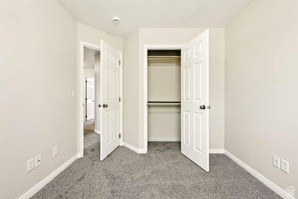 Unfurnished bedroom with carpet floors and a closet