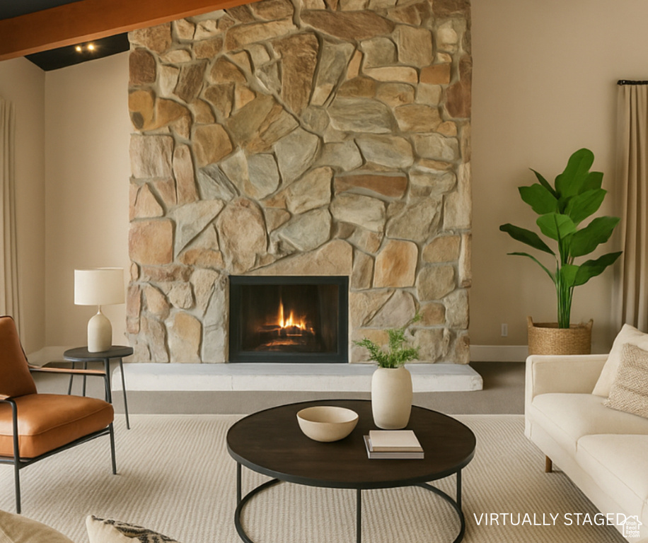 Carpeted living room with a fireplace and baseboards
