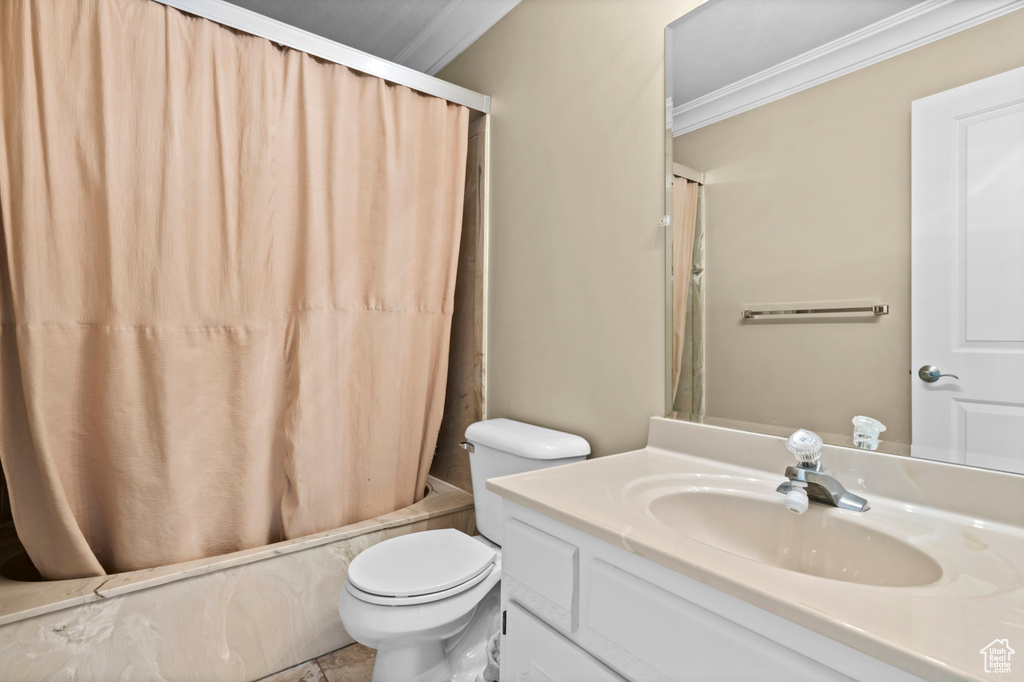 Full bathroom featuring ornamental molding, vanity, and shower / bath combo with shower curtain