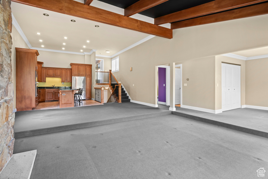 Garage featuring freestanding refrigerator and recessed lighting