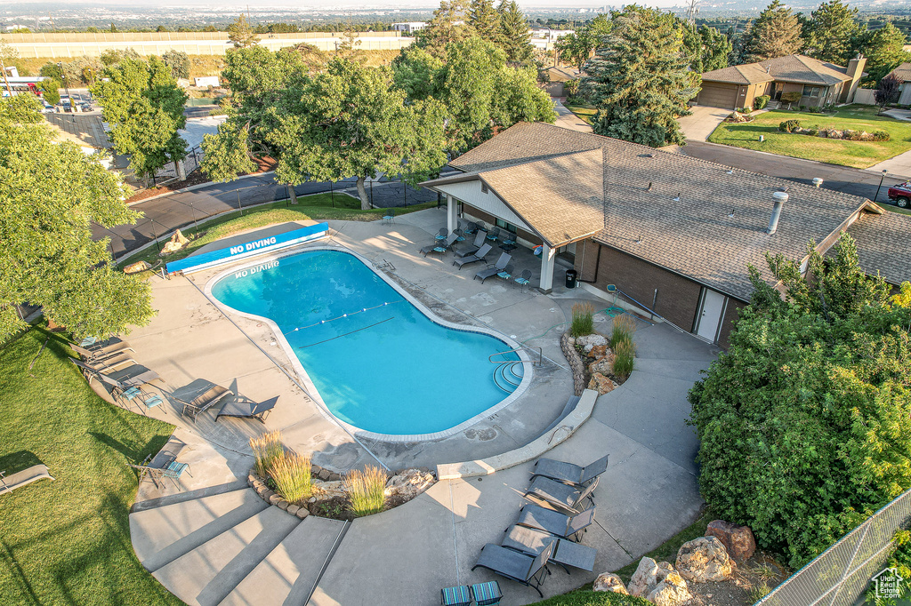 View of swimming pool with a fenced backyard and a patio area