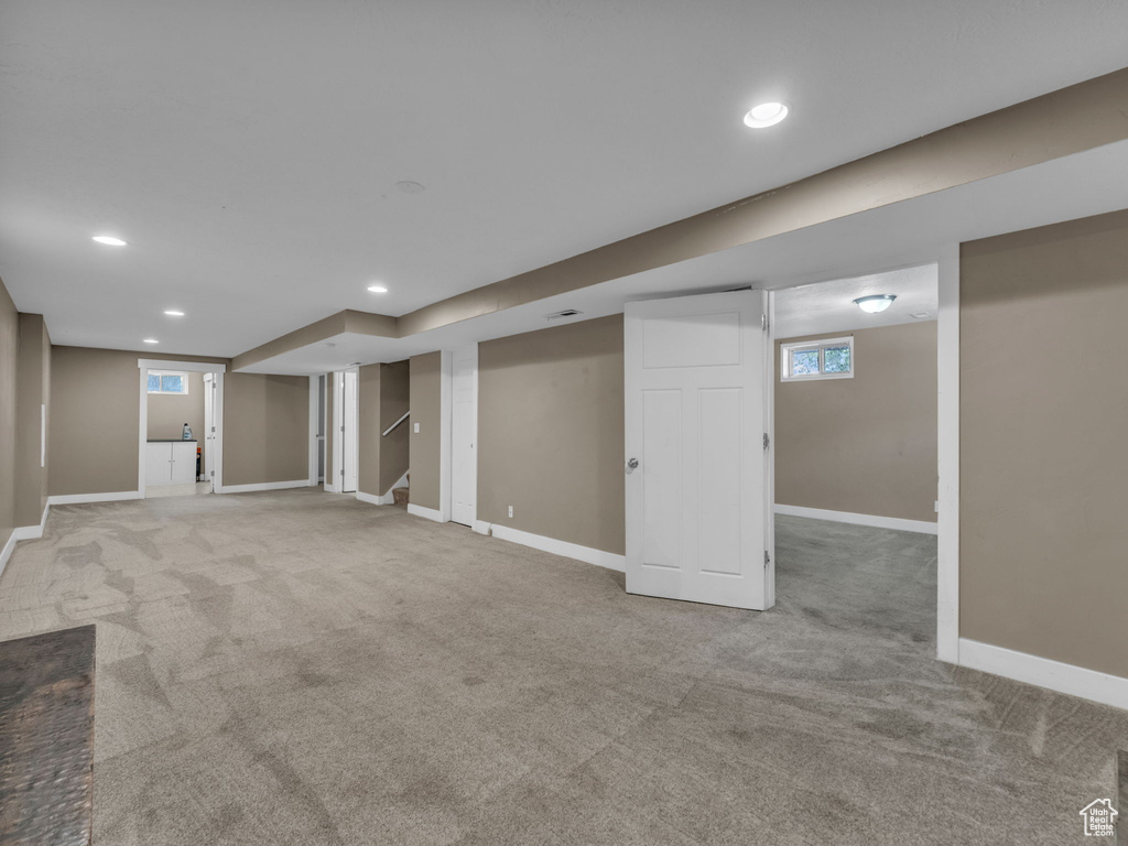 Below grade area featuring carpet floors, recessed lighting, and stairs