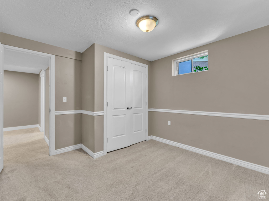 Unfurnished bedroom with carpet floors and a closet