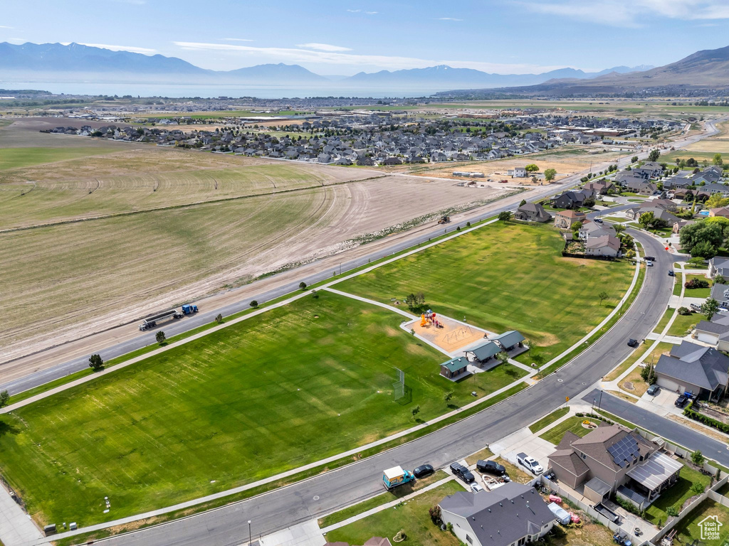 Aerial view of property and surrounding area with mountains and nearby suburban area