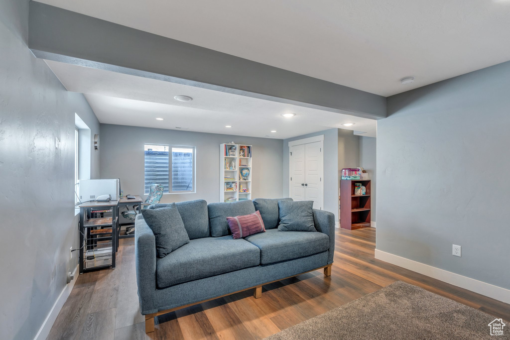 Living area with wood finished floors, an office area, and recessed lighting