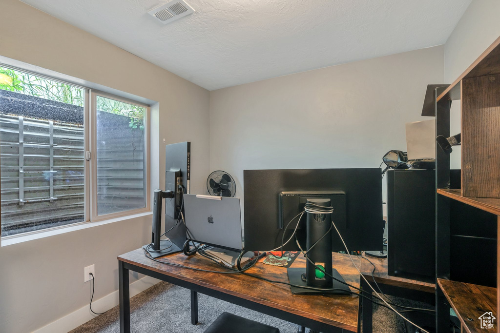 Carpeted office featuring baseboards