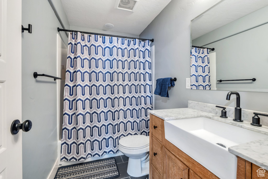 Full bath featuring vanity, tile patterned floors, and a shower with shower curtain